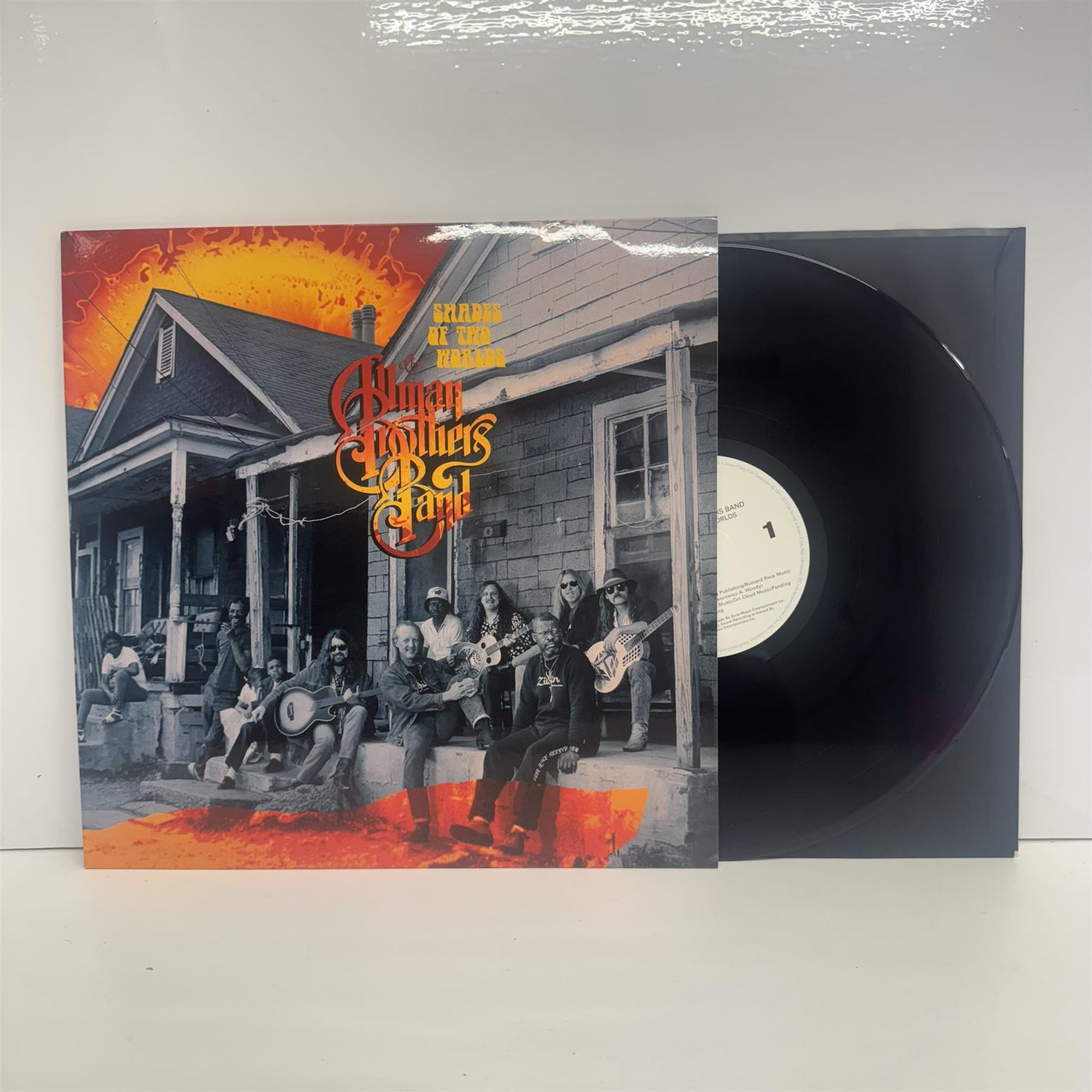 Vinyl record of The Allman Brothers Band’s Shades of Two Worlds, with cover art showing the band playing guitars on a porch.